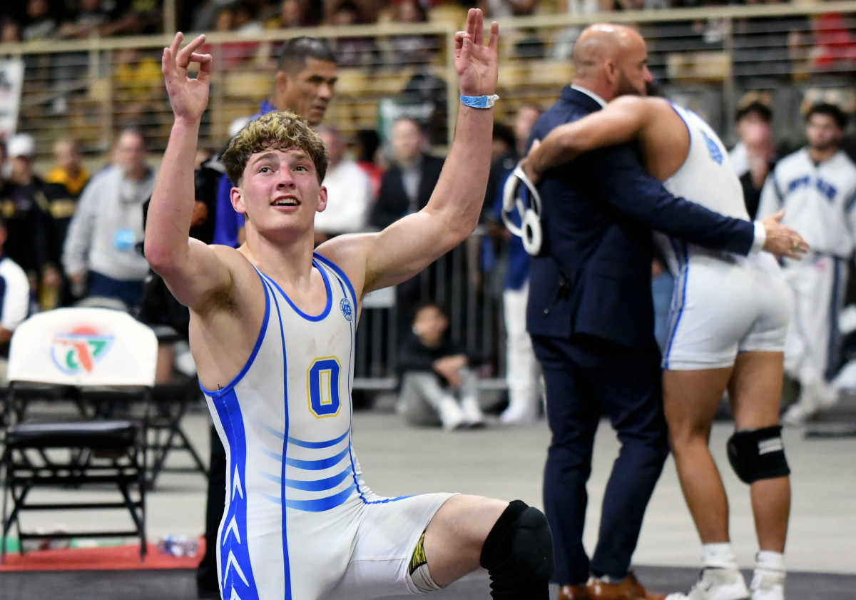 Osceola senior Anderson Heap celebrates with the crowd after winning his third consecutive Class 3A wrestling state championship on Saturday at Silver Spurs Arena in Kissimmee. 