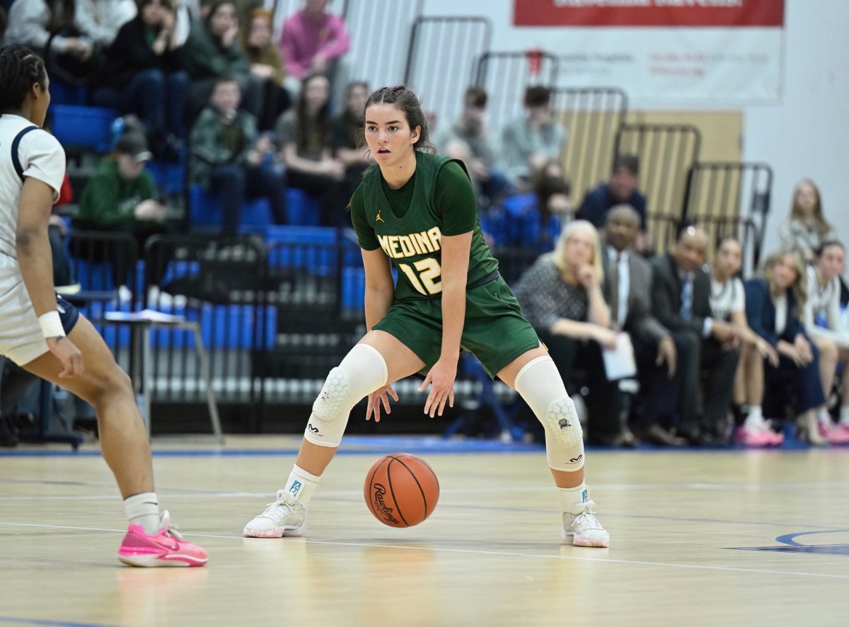 Medina's Olivia Klanac dribbles through her legs and she surveys the defense in a district final game against Archbishop Hoban on March 1, 2024.