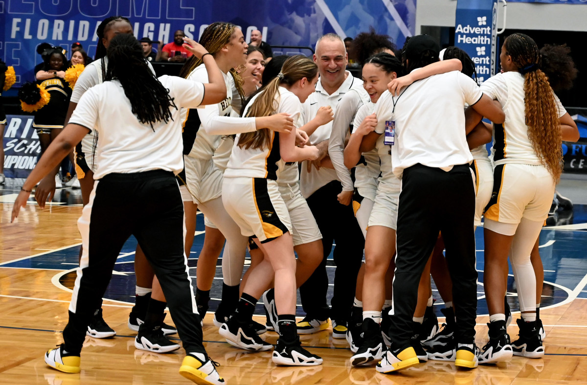 Plantation American Heritage girls basketball players celebrate after winning the Class 5A state championship on Friday at the RP Funding Center in Lakeland.