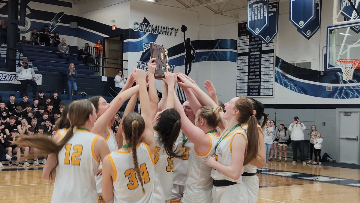 Olmsted Falls players hoist the Division I regional championship trophy after defeating Massillon Jackson on March 9, 2024.