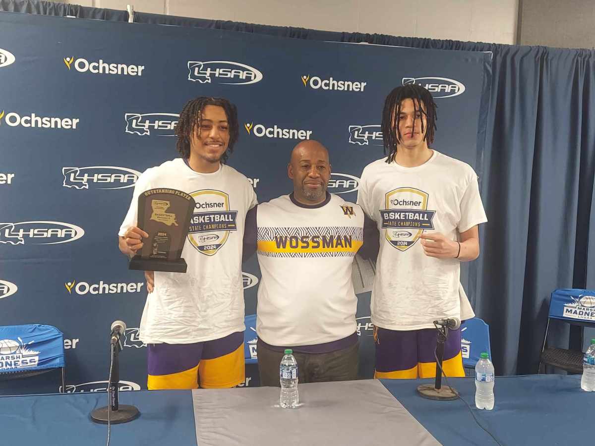 Wossman's Krystian Lewis (from left), coach Casey Jones and Jordan Comanche after the Wildcats claimed the Division II non-select title on March 8, 2024.