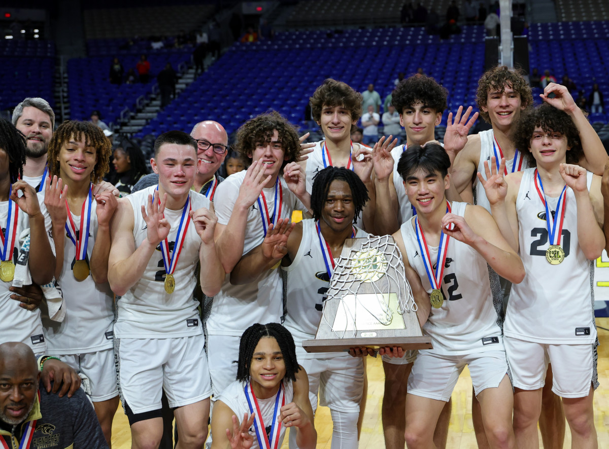 Plano East players post with medals, trophies and the Alamodome net after winning the Texas (UIL) Class 6A state championship on Saturday, completing a 40-0 season.