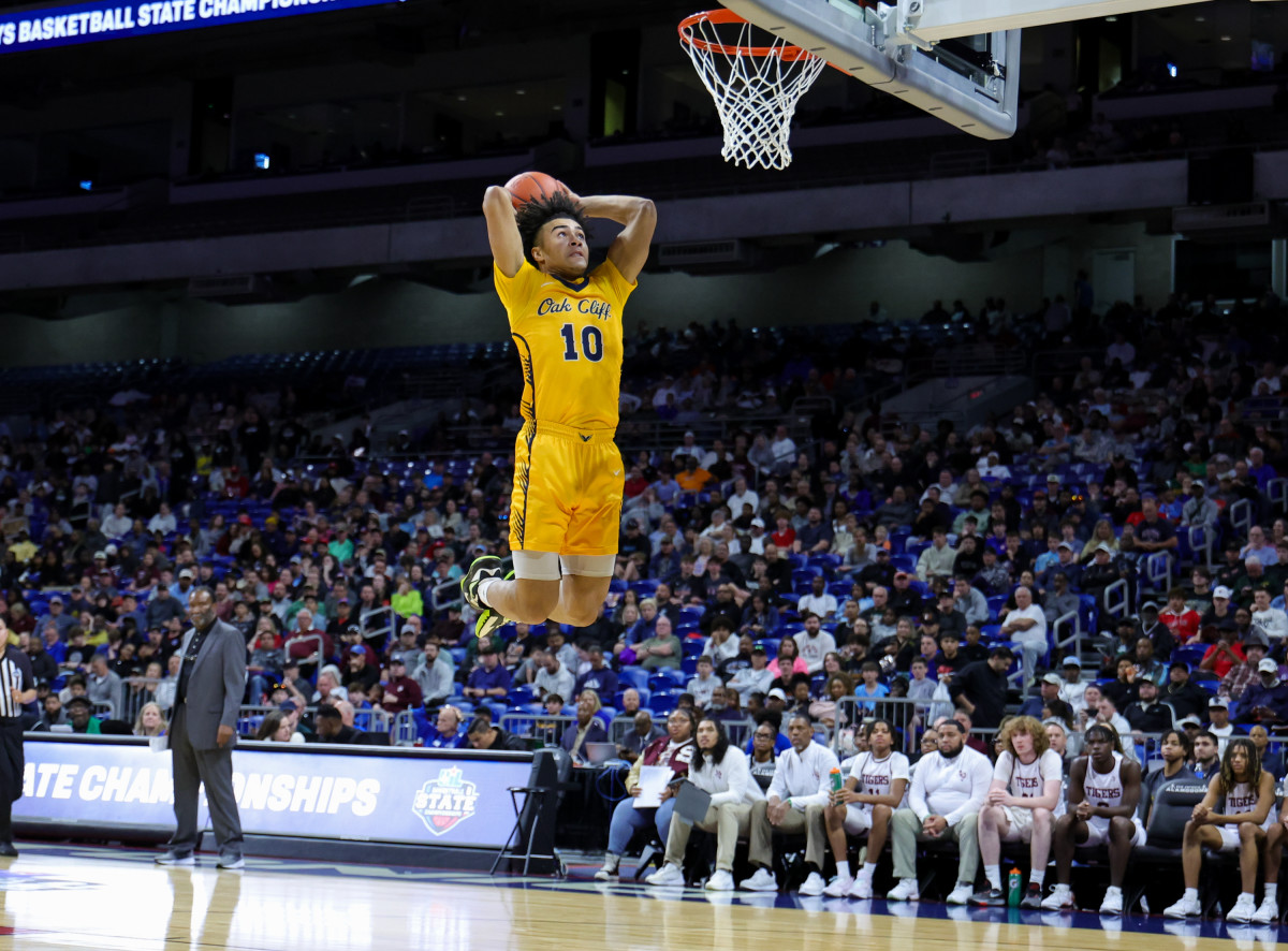 Isaac Williams flies to the hoop as the deflated opposition looks on during a 32-point outing in the Class 4A state title on Saturday at the Alamodome.
