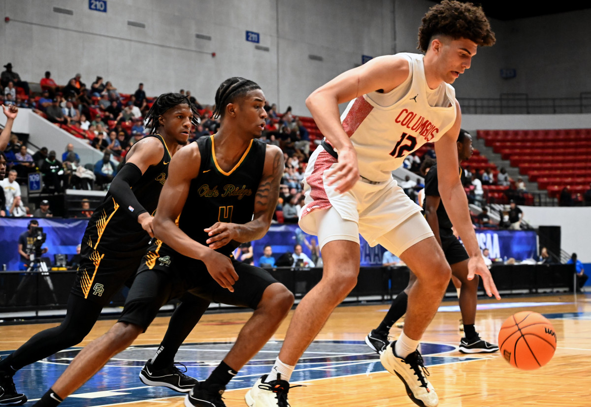 Cameron Boozer (12) from Miami Columbus works the ball against Jordan Tillery from Oak Ridge during the FHSAA Class 7A state title game on Saturday at the RP Funding Center in Lakeland.