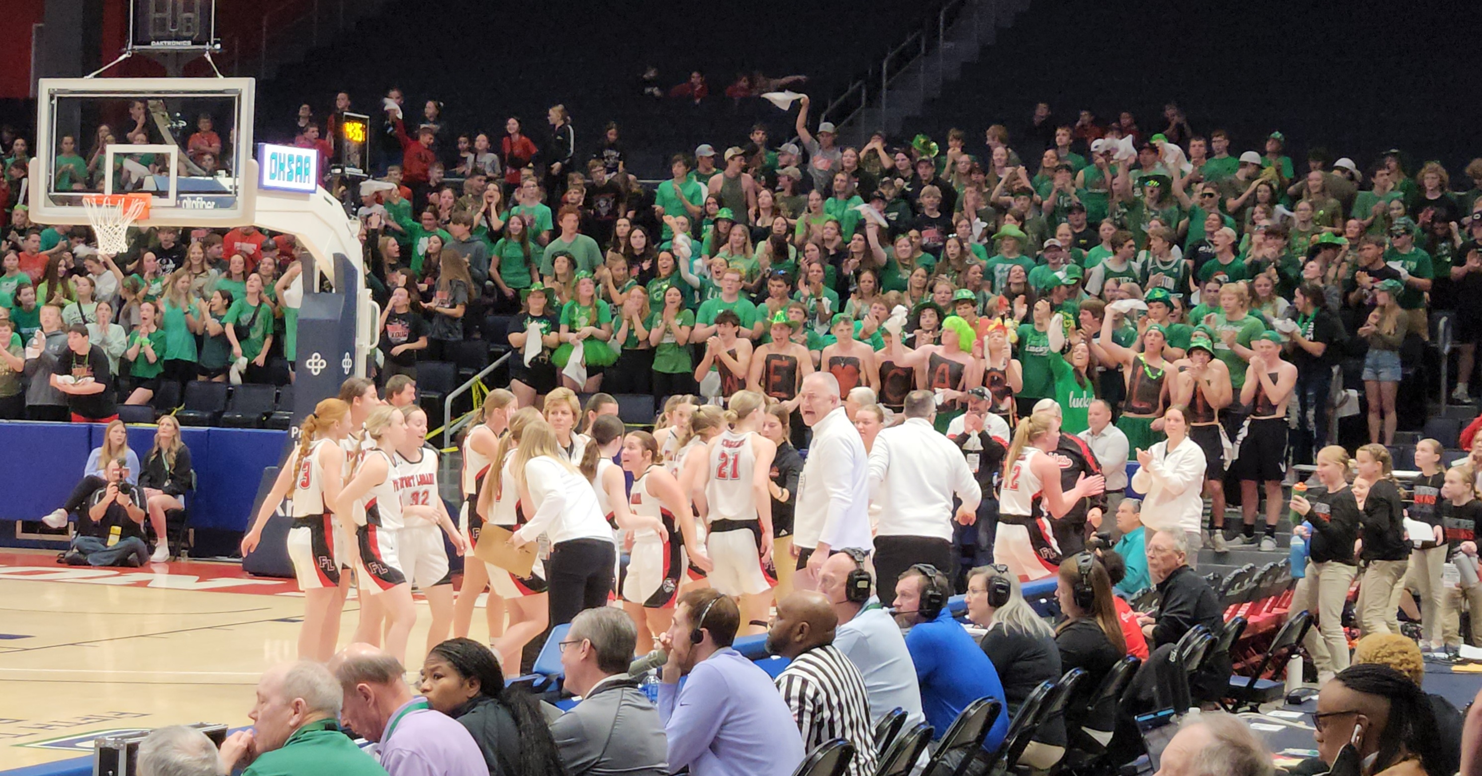 Fort Loramie players celebrate in a timeout during their Division IV state semifinal win over Crestview on March 14, 2024