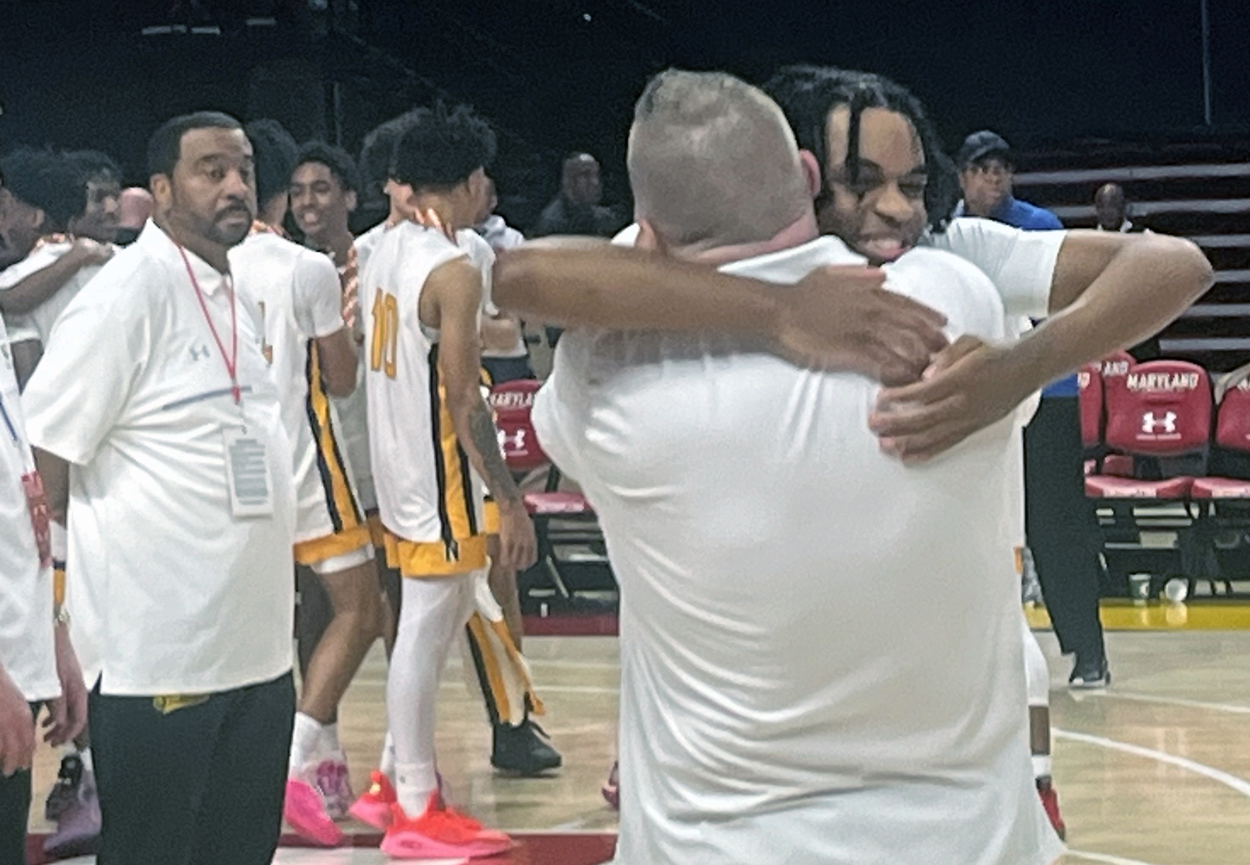 Northeast-AA senior Cameron Albury gets bear-hugged by coach Roger O’Dea during the awards ceremony for the MPSSAA Class 3A boys basketball state championship game. Albury led a furious fourth quarter comeback as the Eagles defeated St. Charles, 69-66. 