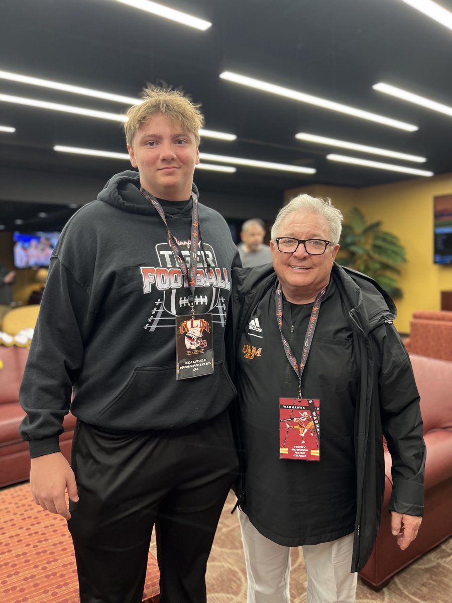 Winnfield senior offensive lineman Eli Little, left, poses with Louisiana-Monroe coach Terry Bowden during the Warhawks' junior day in March.