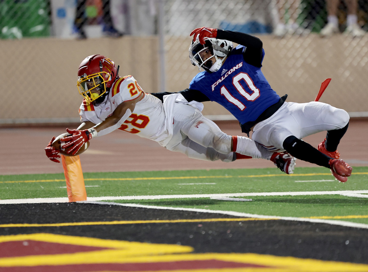Johnnie Brannon IV (28) dives for the pylon for Jesuit against Christian Brothers' Weston Green. Photo: Dennis Lee