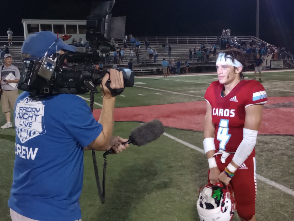 Collinsville senior Hudson Henslick (right) is interviewed by a local TV crew after his 3-TD performance in a 27-14 win against Bartlesville on Sept. 15, 2023. 