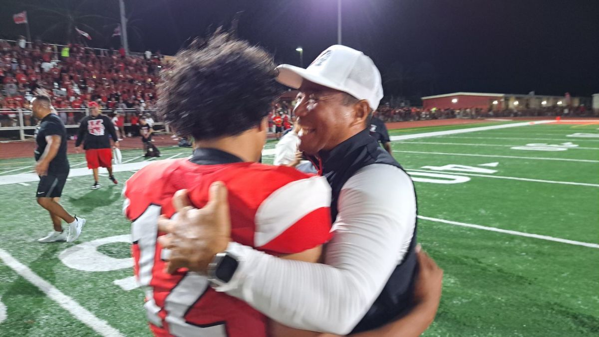 Tuli Tagovailoa-Amosa (12) is greeted by head coach Sterling Carvalho after stunning 30-23 win over St. John Bosco. Photo: Heston Quan. 