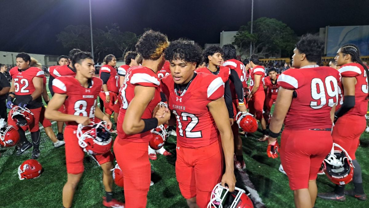 Kahuku players congratulate one another Saturday following 30-23 home win over national No. 2 St. John Bosco. Photo: Heston Quan