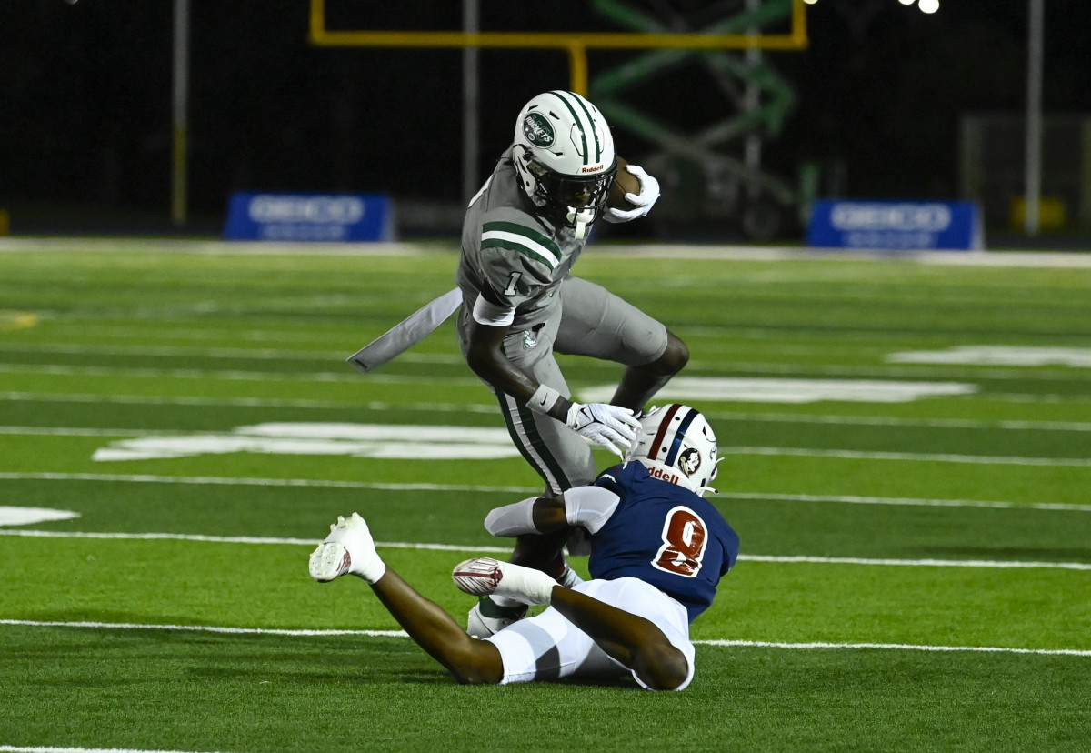 LaWaye McCoy (1) of Miami Central tries to avoid a tackle attempt by Chaminade-Madonna's Kaleb Stewart