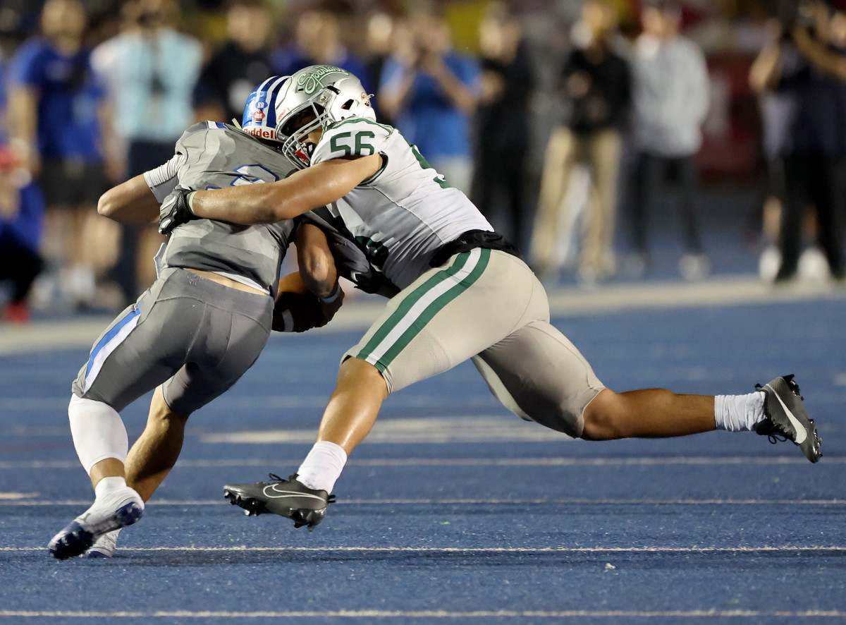 Matthew Johnson (56) with one of his seven tackles. Photo: Dennis Lee