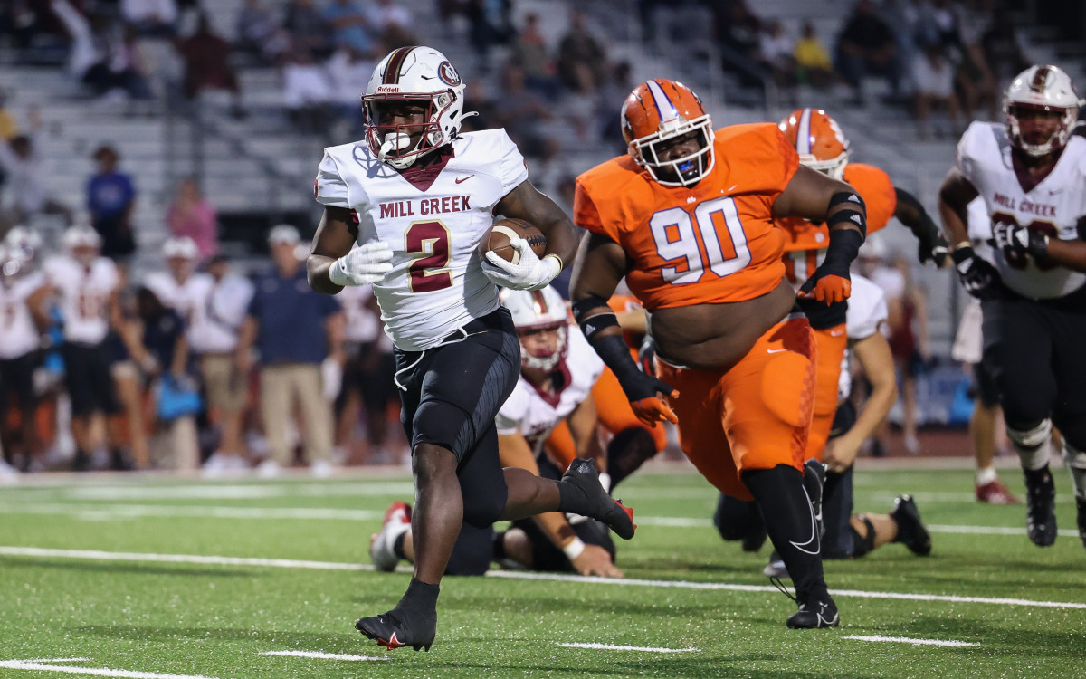 Mill Creek's Cam Robinson (2) breaks off a long run as Parkview's Jeremy Johnson (90) pursues.