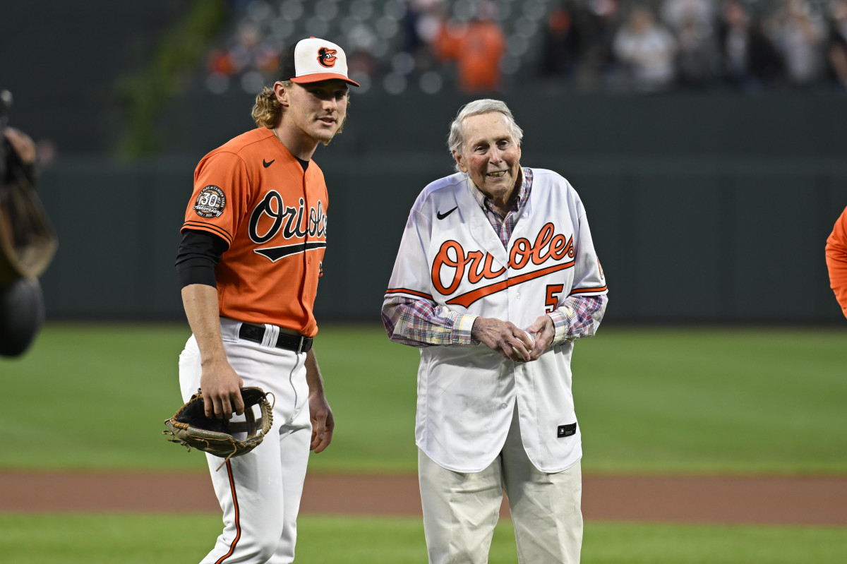 Brooks Robinson, with current Baltimore Orioles' star Gunnar Henderson, prepares to throw out the first pitch during his final visit to Camden Yards, on September 24th, 2022, as he was honored in celebration of the 45th anniversary of his retirement from baseball.