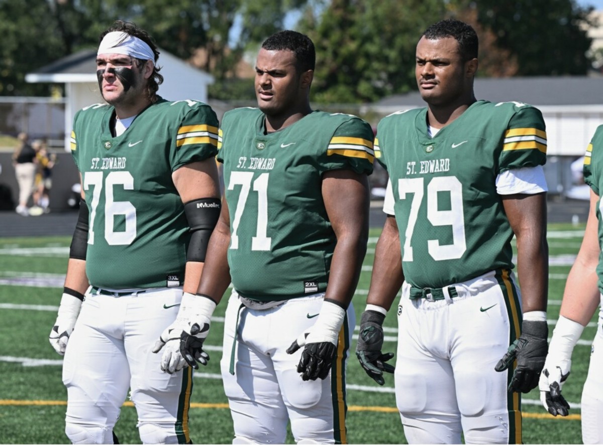 St. Edward offensive linemen Ben Roebuck (No. 76), Devontae Armstrong (No. 71) and Deontae Armstrong (No.79) await the coin toss against River Rouge (Michigan) on Saturday, September 23, 2023. (Photo credit: Jeff Harwell)