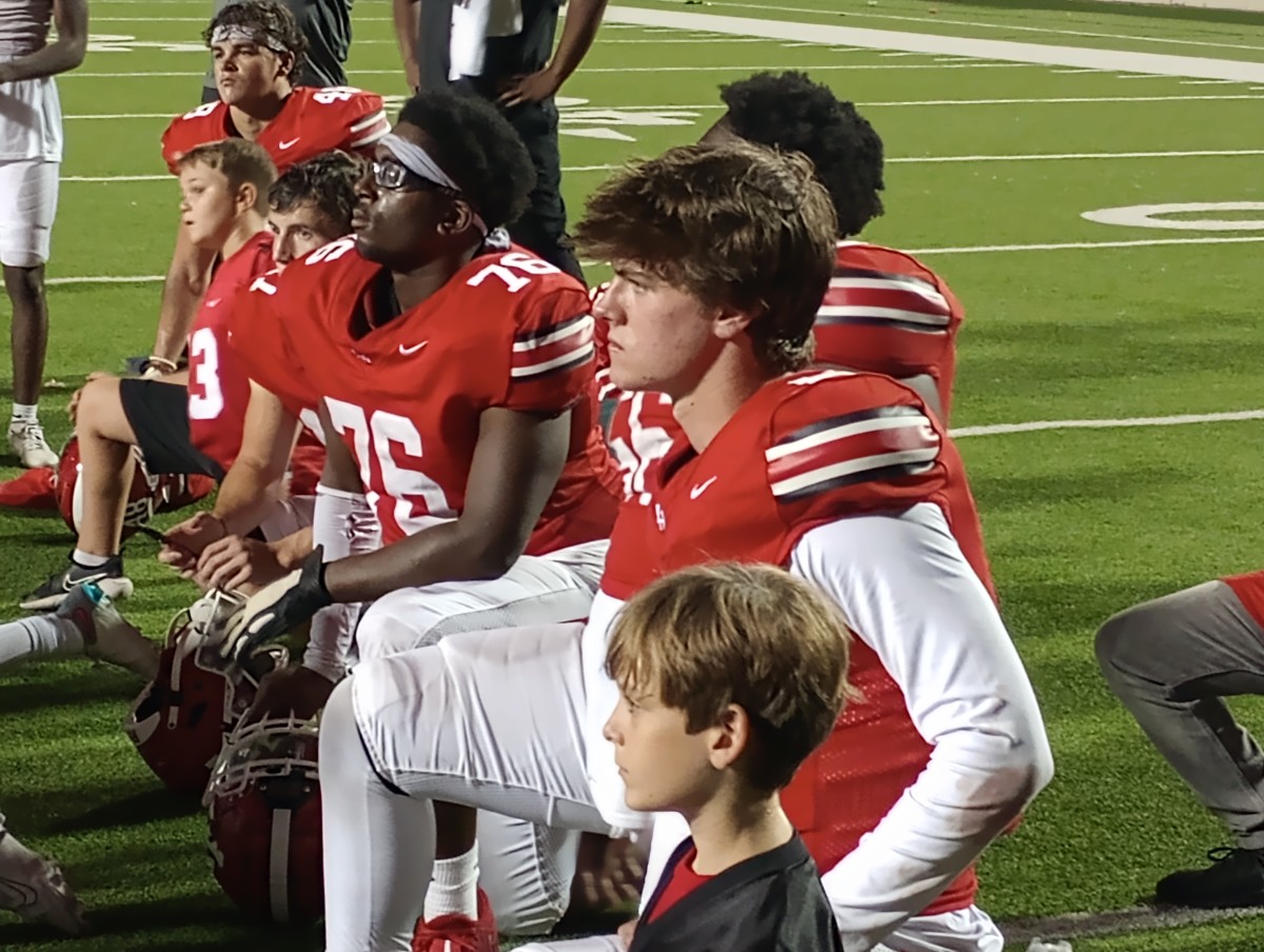 Tripp Holley (front) listens to postgame comments from his coach after Lake Highlands' 41-14 win against Irving MacArthur on Oct. 5, 2023.
