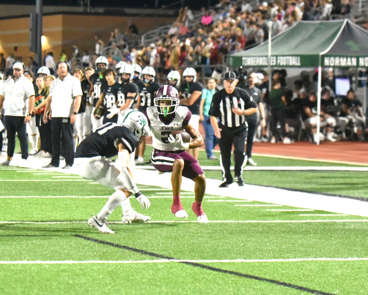 Jenks sophomore Kaydin Jones (with ball) goes up against a Norman North defender during the Trojans' win at the Timberwolves on Oct. 5, 2023.