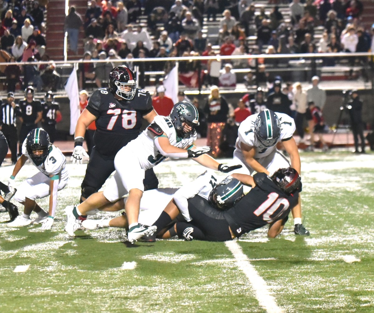 Edmond Santa Fe defenders converge on a Mustang ballcarrier during the Wolves' win against the Broncos on Oct. 6, 2023.