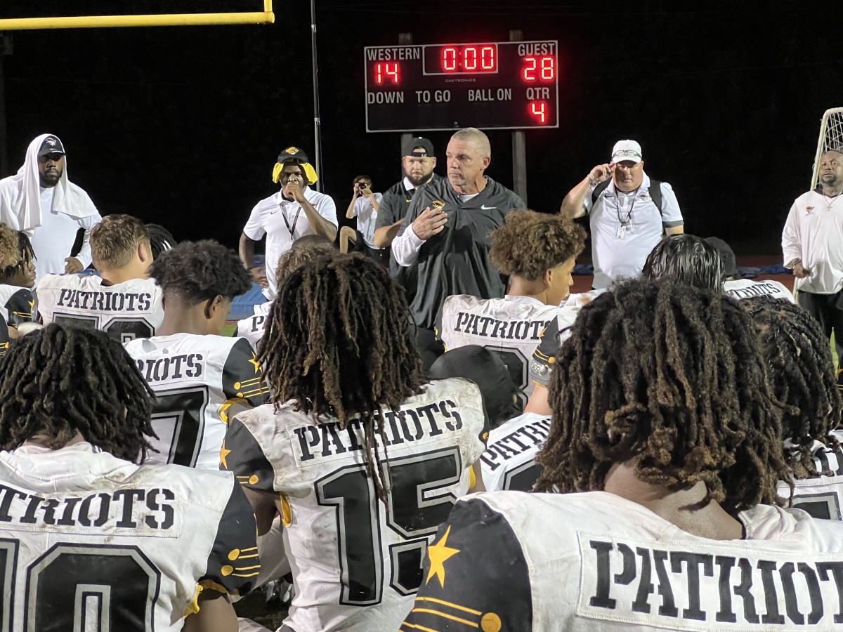 American Heritage coach Mike Smith addresses his team after its 28-14 victory over Western on 10-6-2028.