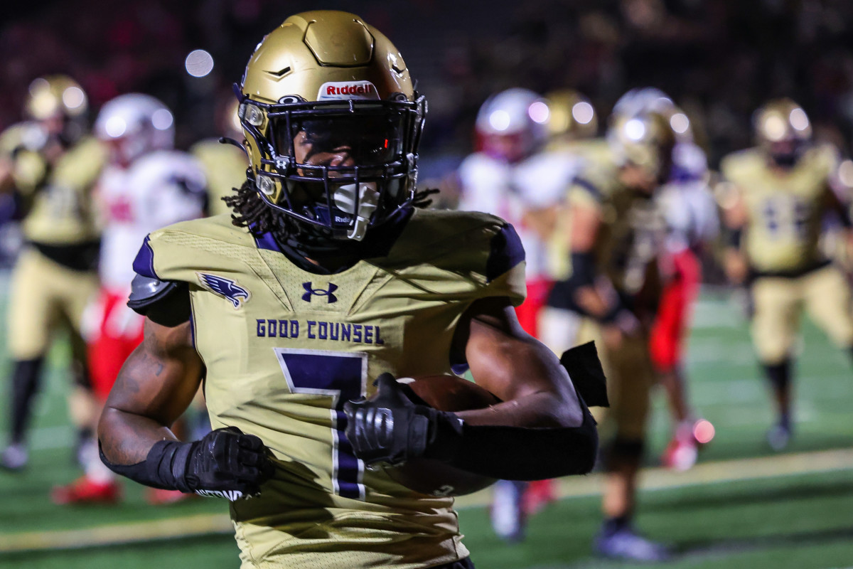 Good Counsel running back Dilin Jones flexes after scoring a touchdown in overtime on Friday. The University of Wisconsin commit's score was the difference as the Falcons outlasted DeMatha, 35-28, in a Washington Catholic Athletic Conference game in Olney, Maryland.