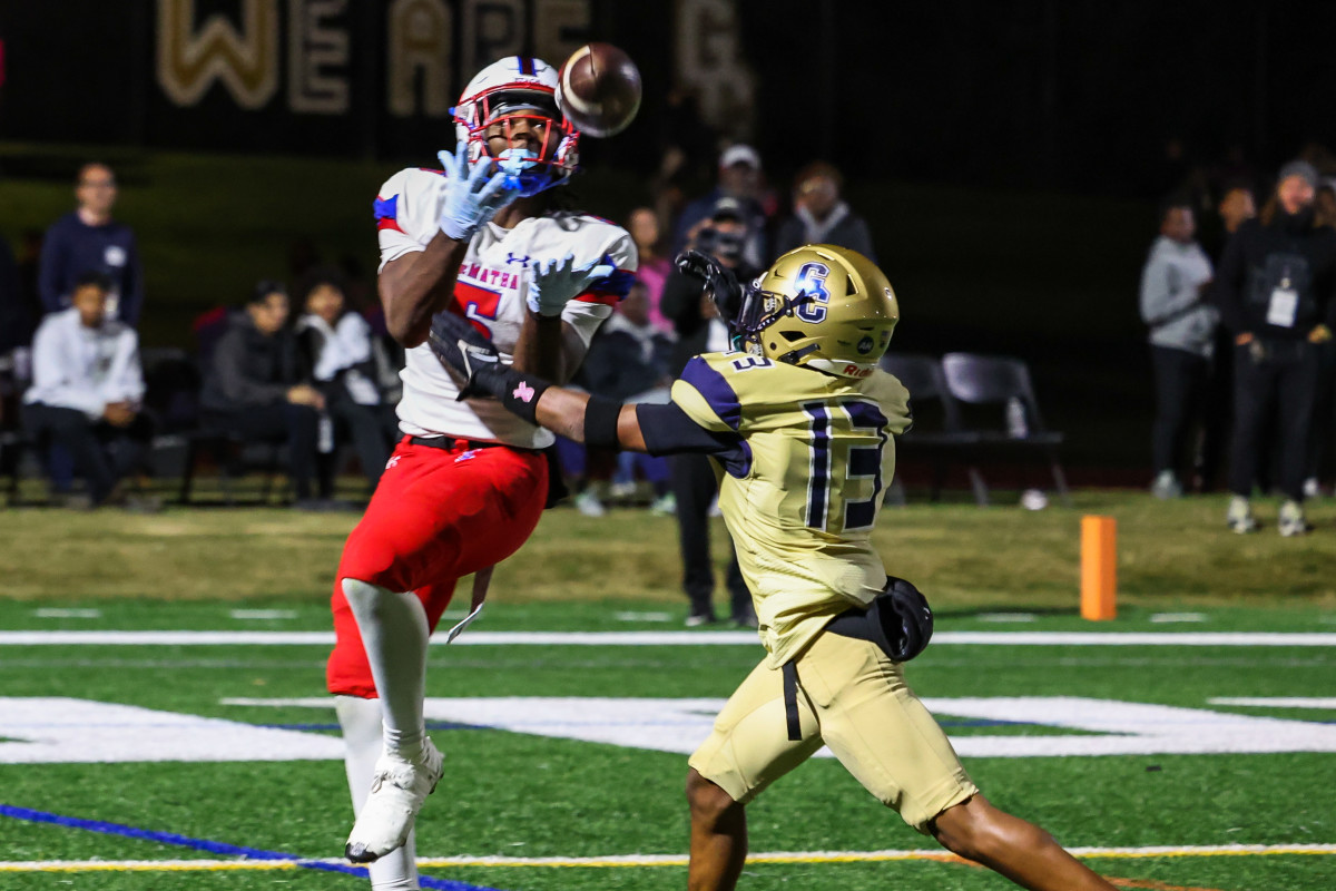 DeMatha's Emmanuel Dyson looks in a touchdown pass as Good Counsel's Colin Douglas defends during Friday evening's battle of Maryland's Nos. 1 and 2 squads. The No. 1 Falcons won their sixth straight with a 35-28 overtime victory over the second-ranked Stags in Olney.