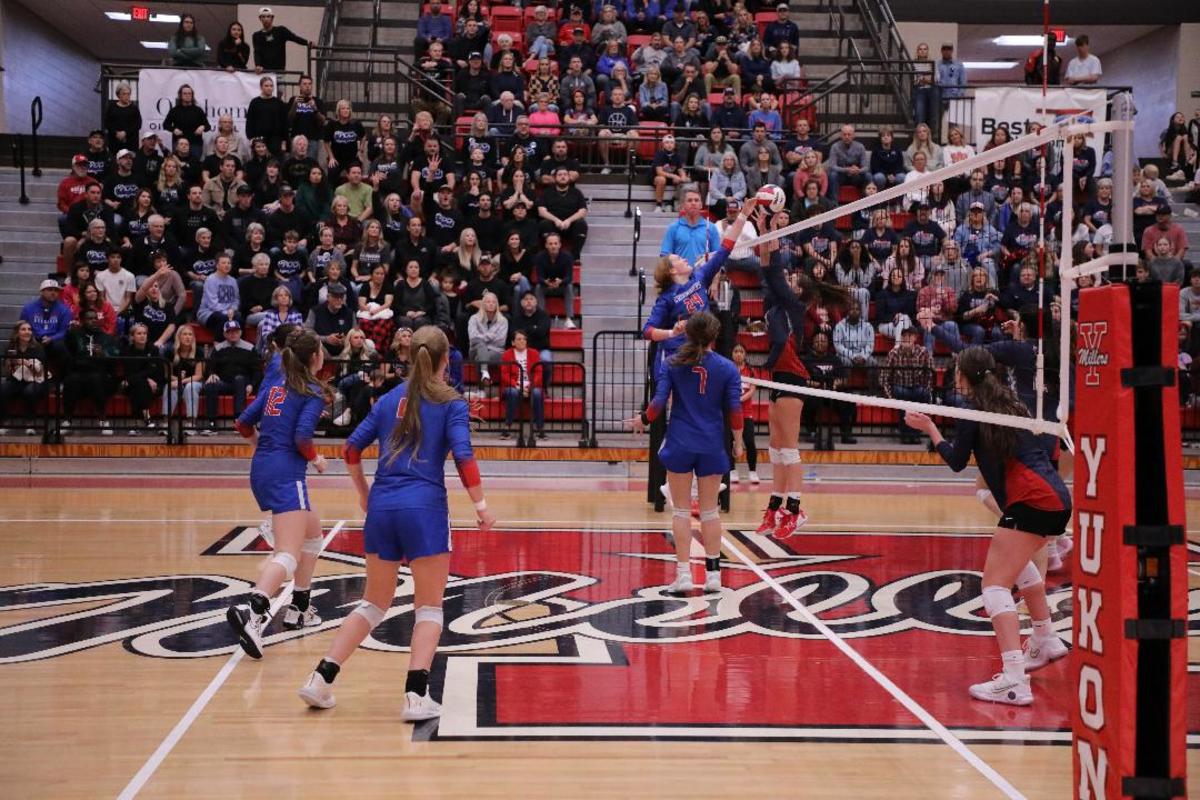 Christian Heritage Academy junior outside hitter Hannah Joy Nuthman lunges over the net during the Class 3A volleyball state championship match at Yukon High School.