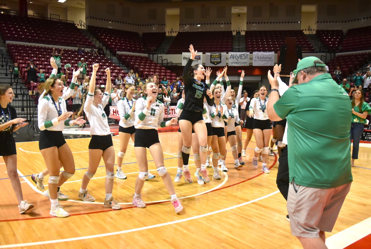 Bishop McGuinness players celebrate after winning the Class 5A volleyball title Oct. 21, 2023.