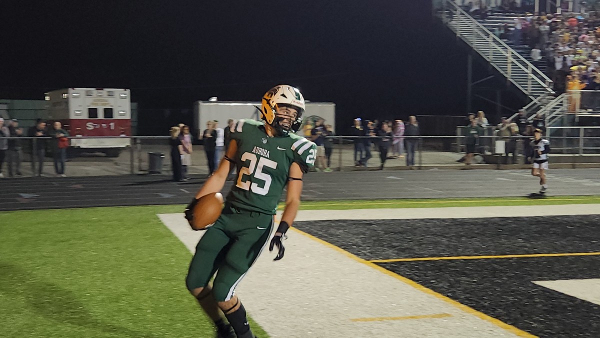 Aurora running back Enzo Catania looks back after scoring a touchdown in the first quarter of Aurora's 41-7 playoff win over Alliance on Friday, October 27, 2023. (Photo credit: Ryan Isley, SBLive Sports)