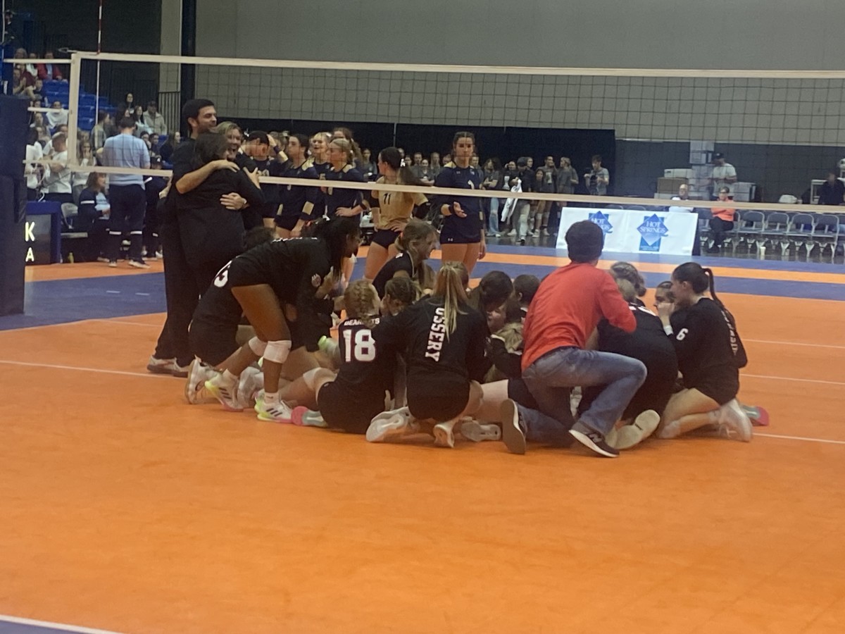 Brookland players swarm the court after winning the Class 4A state volleyball championship Oct. 28, 2023.