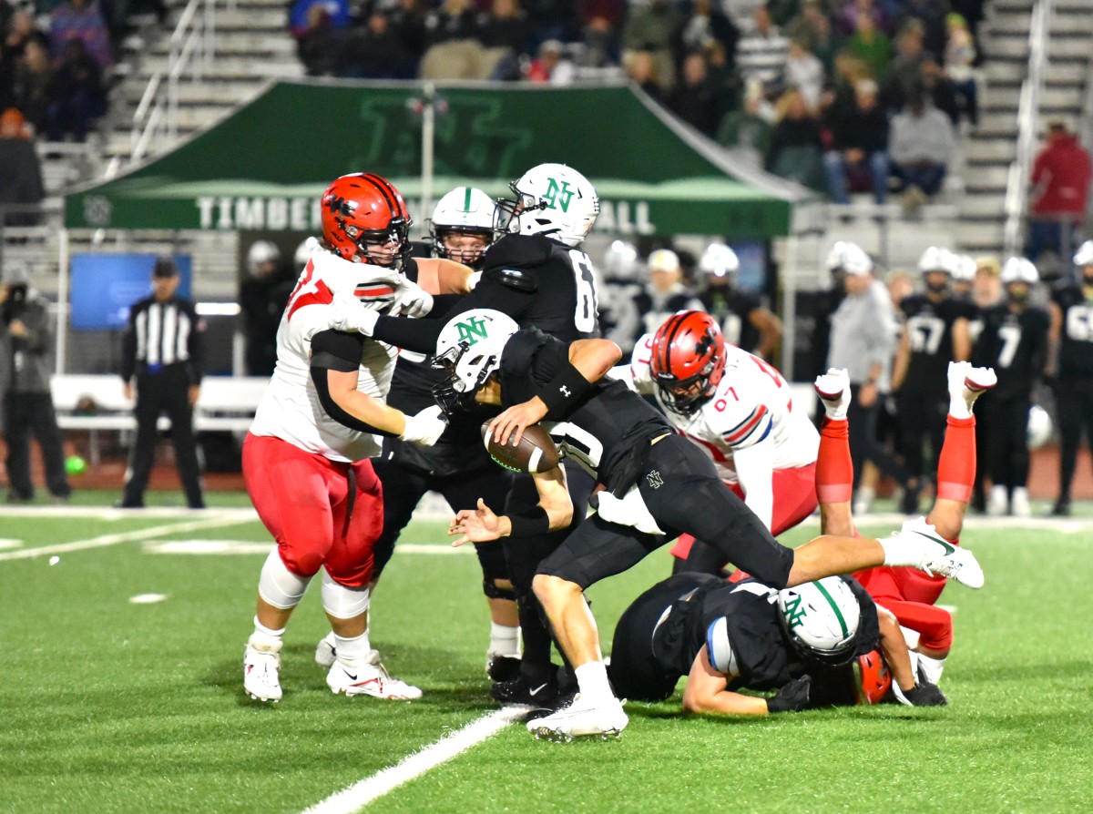 Norman North quarterback Owen Eshelman (with ball) takes a keeper during the Timberwolves' game against Westmoore on Oct. 27, 2023.