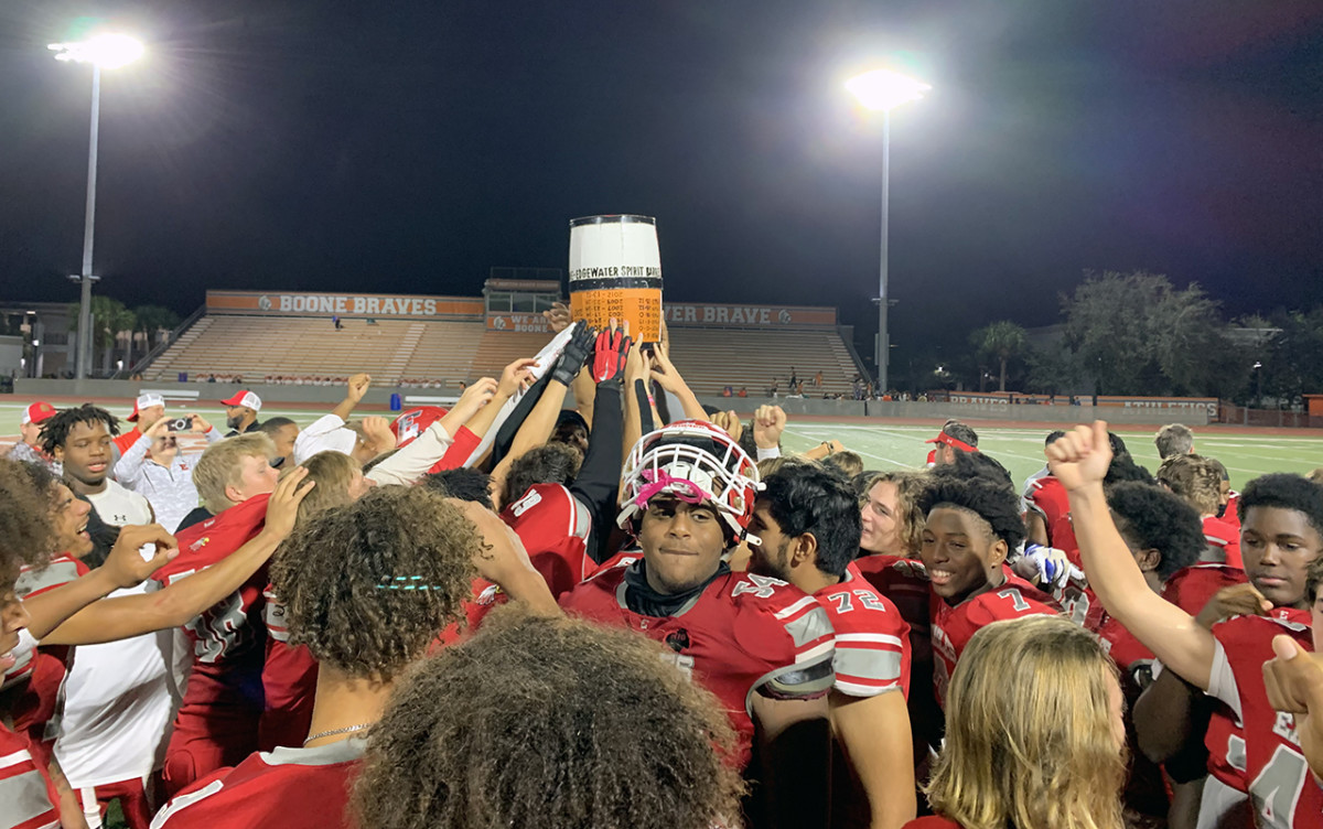 Edgewater player lift up the "Spirit Barrel" which they captured with their 42-14 victory over rival Boone, Friday night. With the win, the Eagles finished the 2023 regular season unbeaten at 10-0.