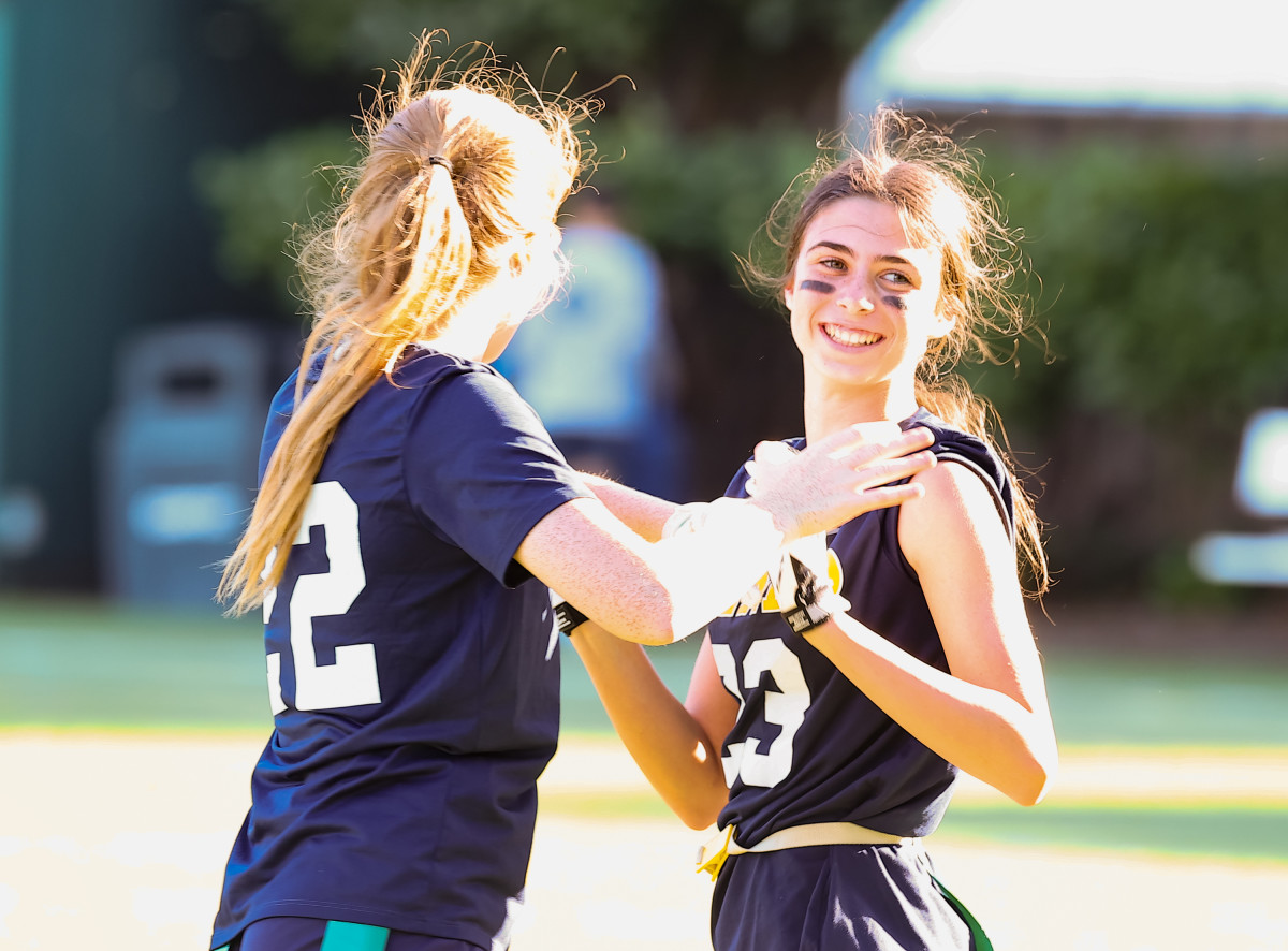 Steve Young's freshman daughter Laila (23) enjoys a moment with sophomore teammate Sophie Housser.