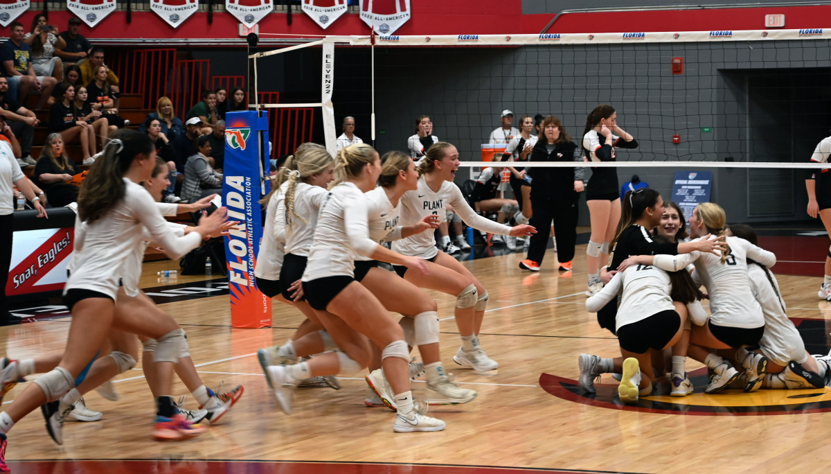 Tampa Plant volleyball players mob each other at midcourt after winning the Class 3A girls volleyball state championship Saturday at the FHSAA Finals at Polk State College in Winter Haven.