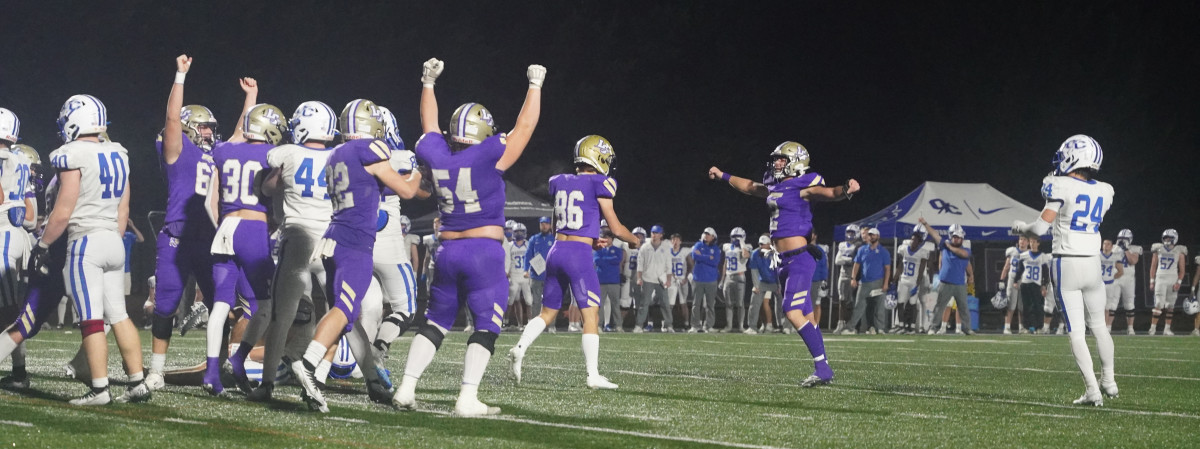 Lumpkin County players raise the arms in celebration after Will Staples' game winning field goal.