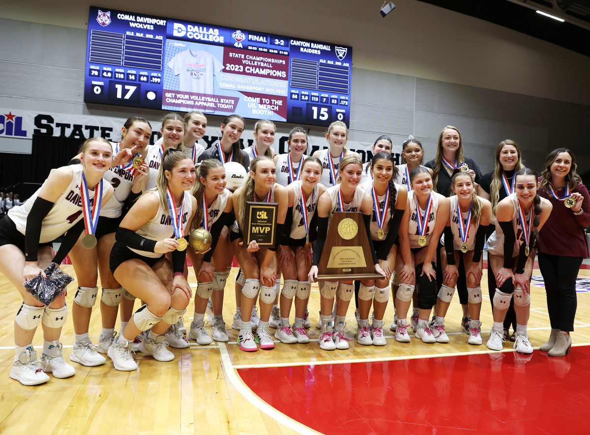 Comal Davenport poses with the UIL Class 4A state volleyball title trophy on Saturday in Garland.