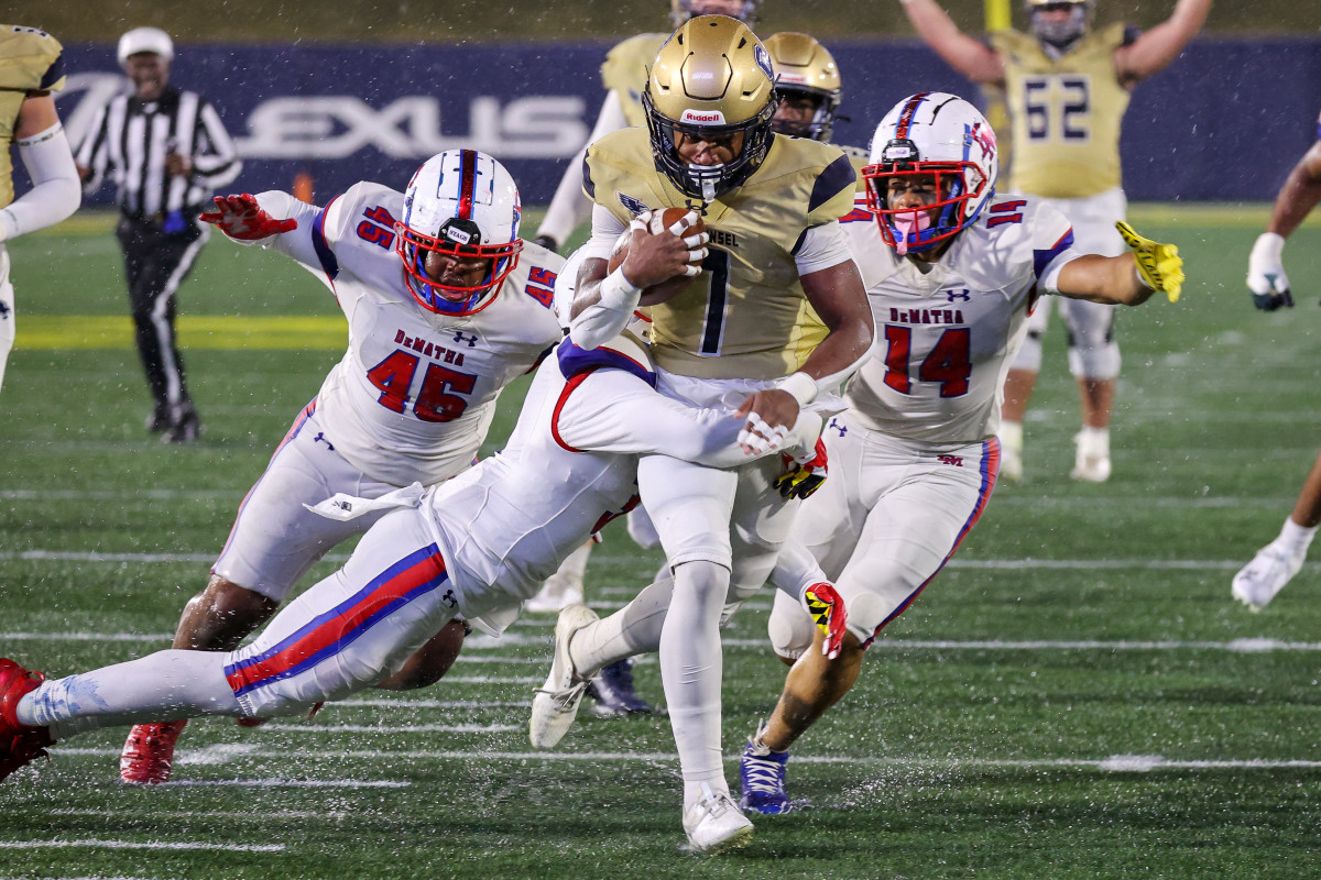 Good Counsel senior running back, who will play at Wisconsin next year, splashes through the DeMatha defense on his way to scoring the game's only touchdown in the Falcons' 7-0 win over DeMatha in the WCAC football championship game at Navy.