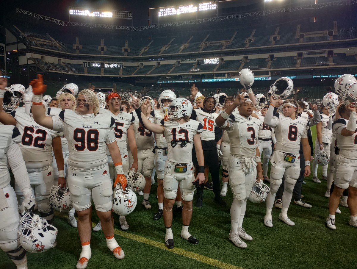 Aledo players salute their fans following the Bearcats' 5A Division I regional playoff win on Nov. 24, 2023.