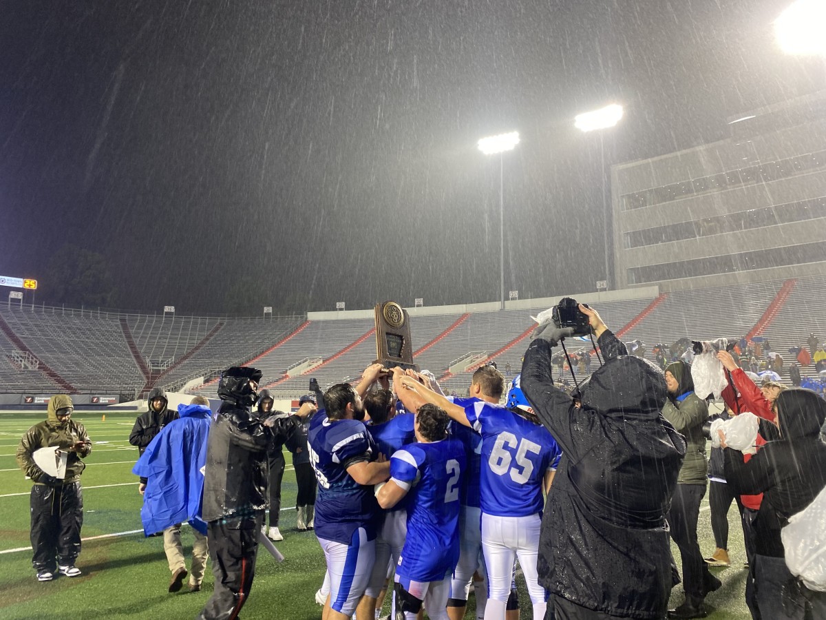 Rector players celebrate after defeating Spring Hill in overtime to win the Arkansas 8-man state championship on Nov. 30, 2023.