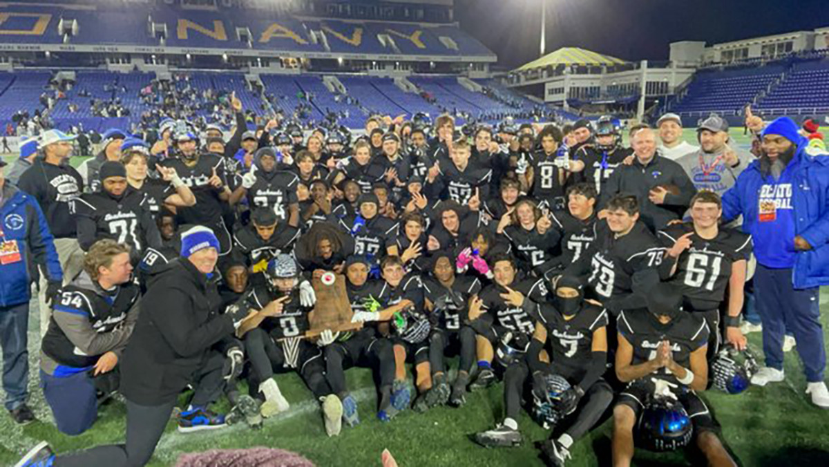 The Stephen Decatur Seahawks pose with their MPSSA state championship trophy after defeating Huntingtown, 21-13, Thursday night at Navy-Marine Corps Stadium. It was the Hawks first state title.
