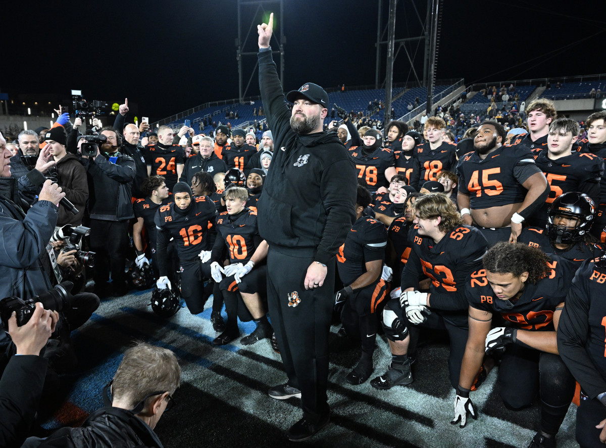 Massillon head coach Nate Moore holds up one finger signifying that the Tigers had won the state championship with a win over Archbishop Hoban on November 30, 2023. Photo credit: Jeff Harwell, SBLive Sports