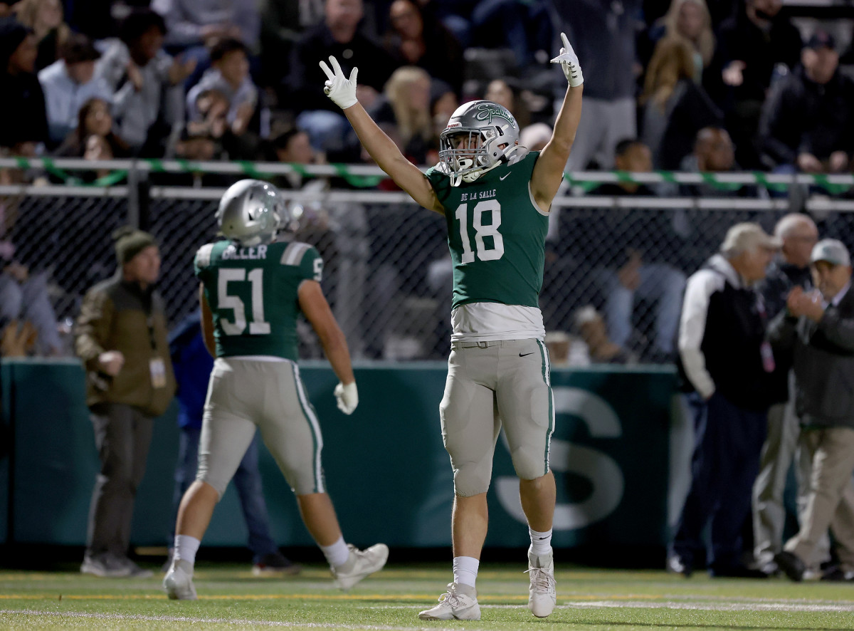 Drew Cunningham (18) celebrate with the game in hand as Chris Biller (51) walks off the field during a 41-0 CIF Northern California Division 1-AA championship win over Clovis North on Dec. 1, 2023. 