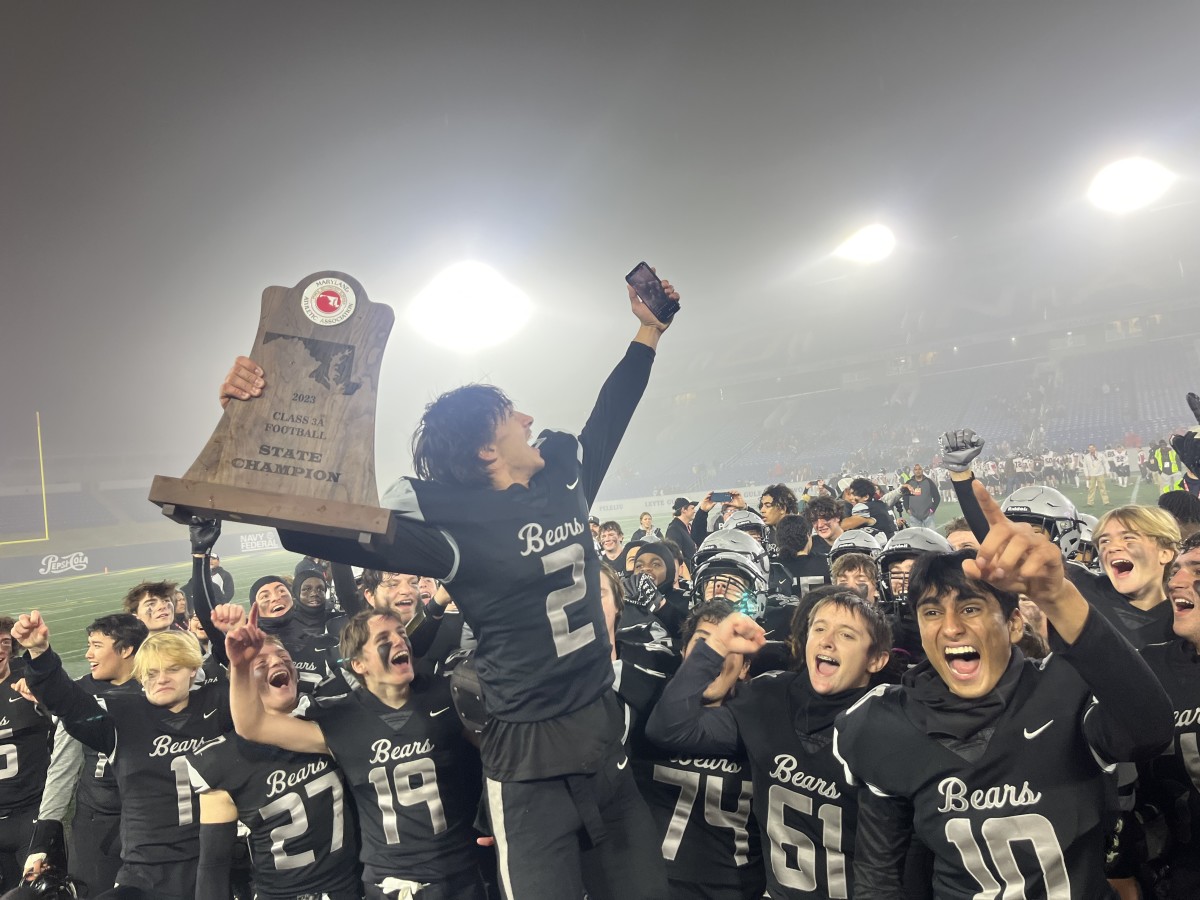 Evan Austin holds up state 3A trophy while taking a selfie after game. The Charlotte commit accounted for 464 yards in 42-35 win over Linganore, completing a 14-0 season for Oakdale.
