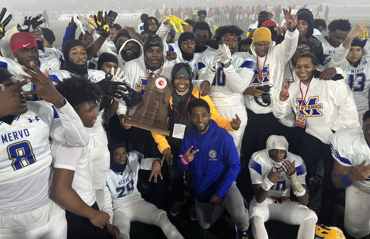 Trailing at halftime, Mervo rallied in the second half to defeat previously undefeated and defending champ North Point in the Class 4A/3A state final at Navy. It’s the second 4A/3A title in three seasons for the Baltimore City program. Baltimore Mayor Brandon Scott (center in blue) was on hand to join in the trophy presentation celebration.