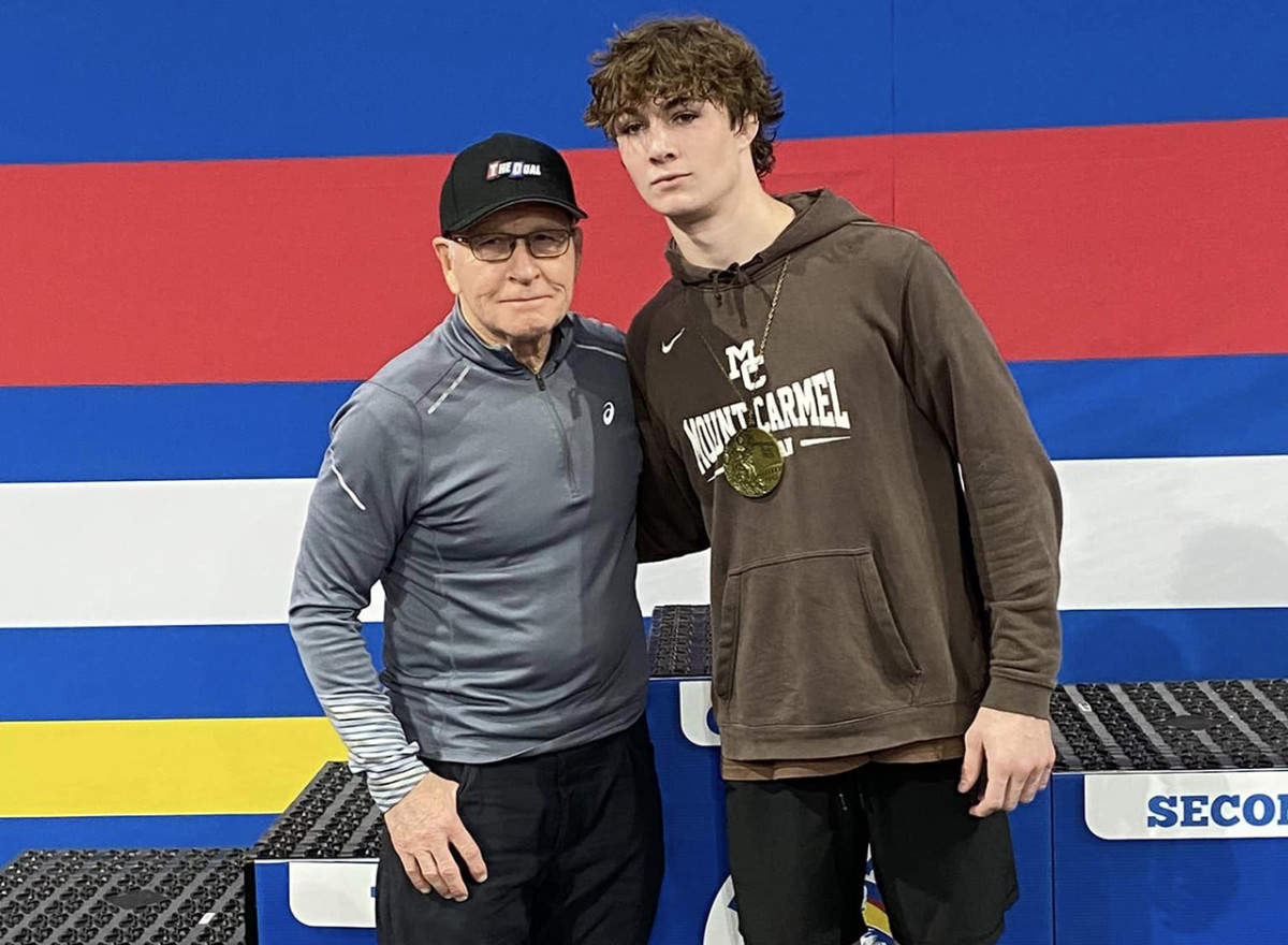 Mt. Carmel (Illinois) wrestler Eddie Enright poses with wrestling legend Dan Gable after Enright won the 157lbs. weight class at the Dan Gable Donnybrook last weekend in Iowa.