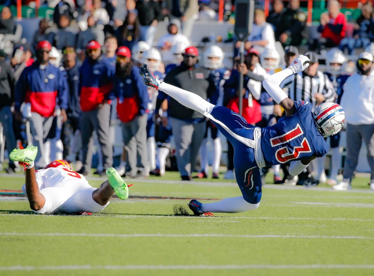 Chaminade-Madonna's Denairus Gray tumbles to the turf after making a catch against Clearwater Central Catholic's Artrevian McClellan in the FHSAA 1A state championship game. 12/7/2023