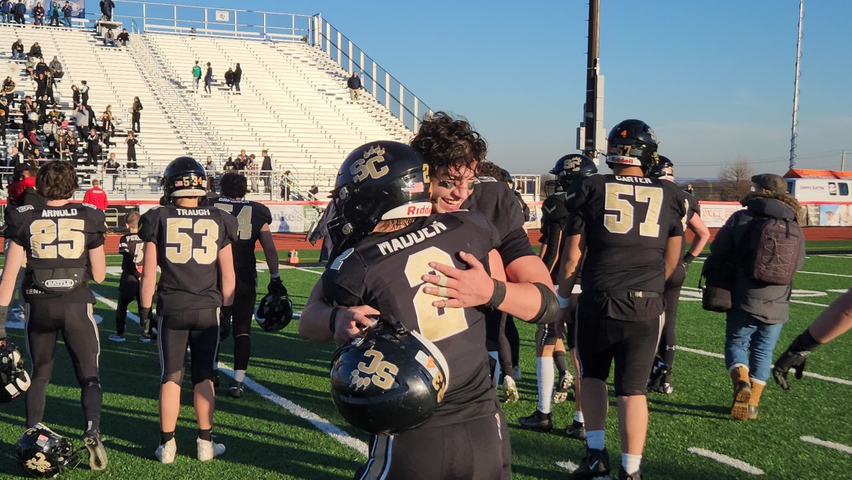 Southern Columbia senior Cater Madden hugs fellow senior Garrett Garcia after the Tigers won the 2023 PIAA Class 2A state title on December 8, 2023. Photo credit: Ryan Isley, SBLive Sports