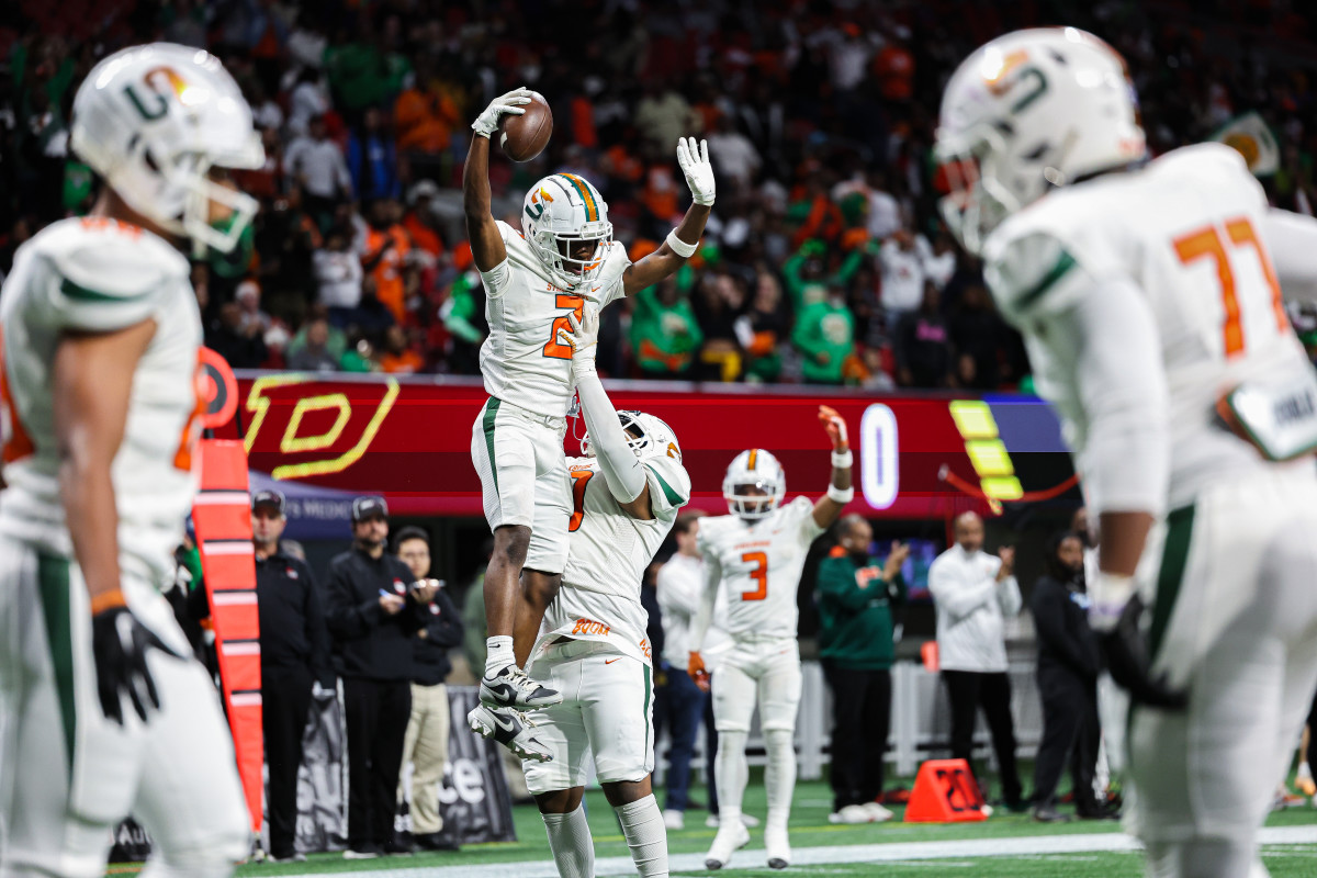 Stockbridge's Jayden Howard gets a "lift" after scoring a touchdown against Perry in the Georgia 4A state championship game. 12/12/2023