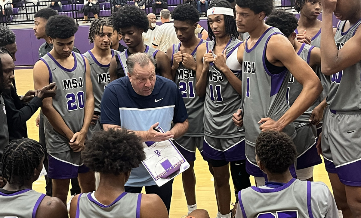 Mount St. Joseph coach Pat Clatchey gives instructions during a timeout in Monday’s game against Mount Carmel. Clatchey became the third coach in Maryland high school boys basketball history to win 800 games.