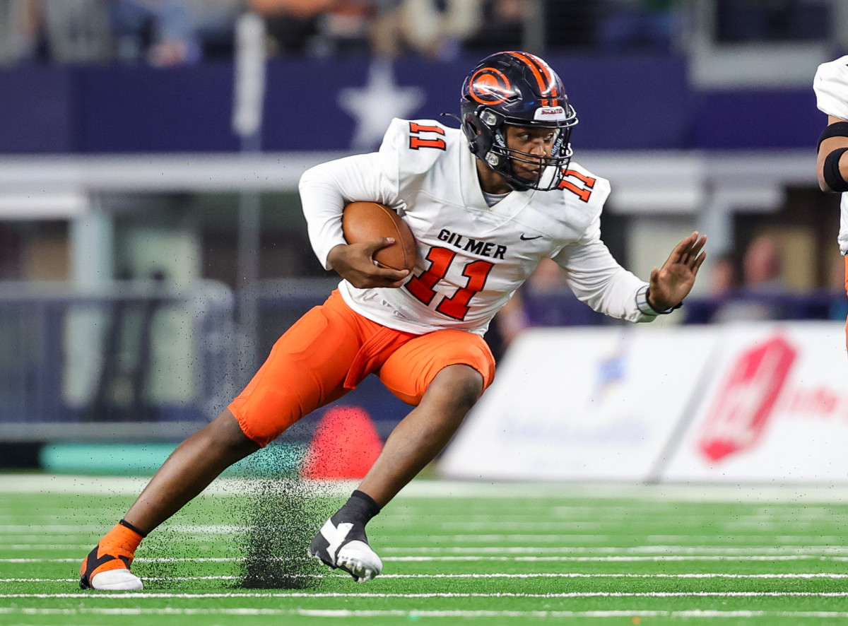 Gilmer QB Caden Tennison braces for contact during the 2023 4A Division II state championship against Bellville at AT&T Stadium.